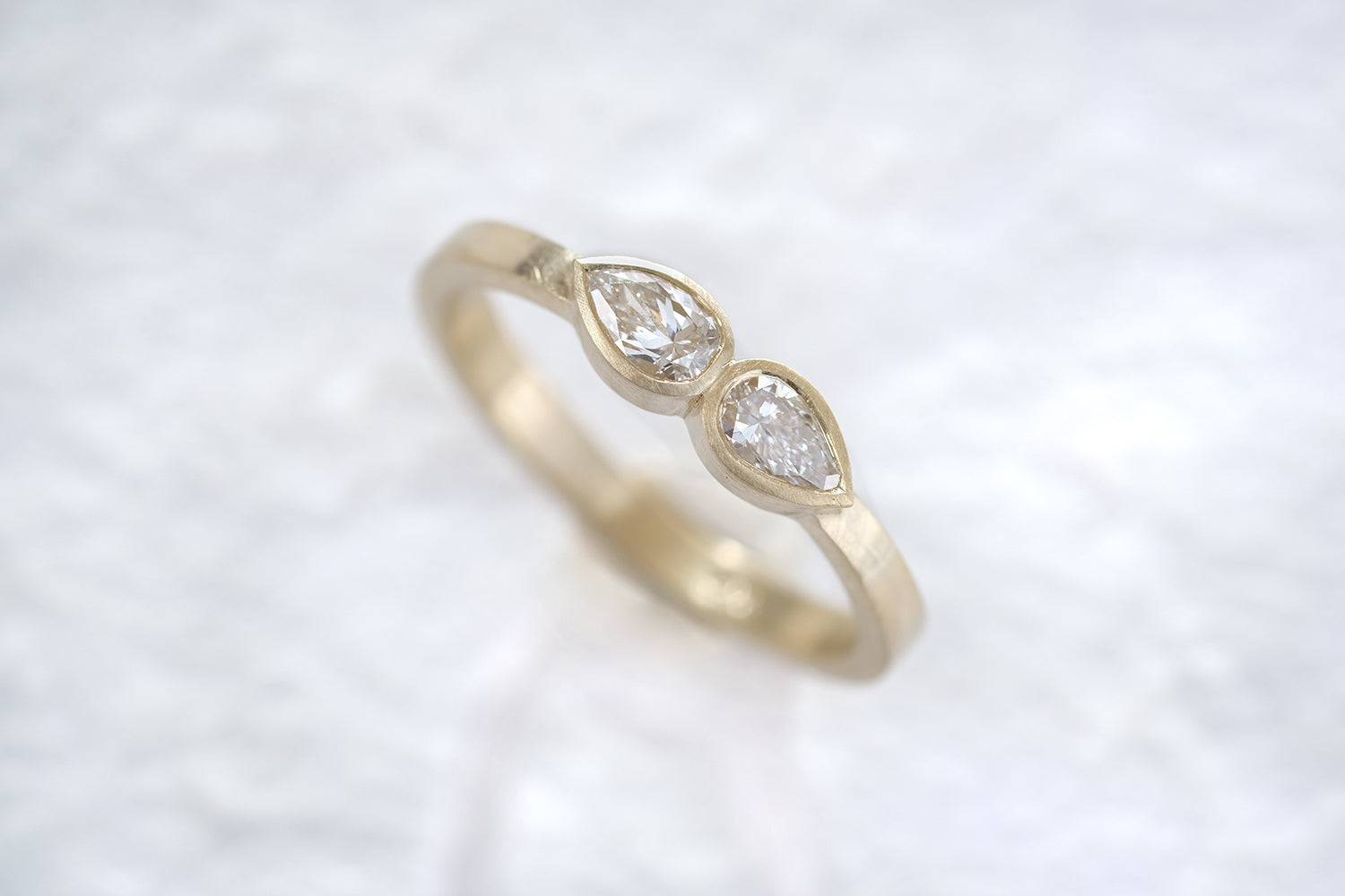 Gold Engagement Ring Set With A Pair Of Drop-Shaped Diamonds