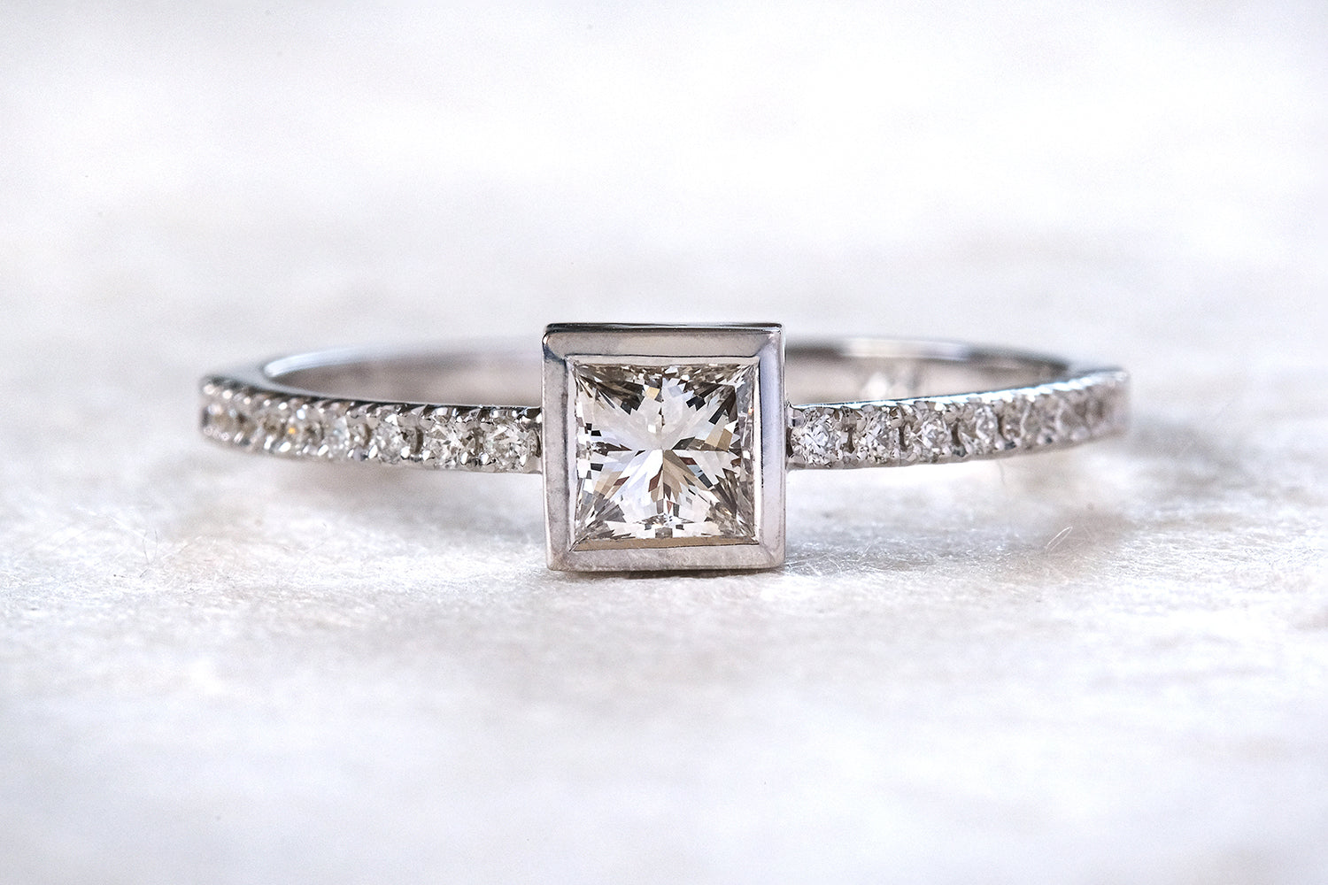 Engagement Ring With A Princess Cut Diamond And Diamonds On the Sides