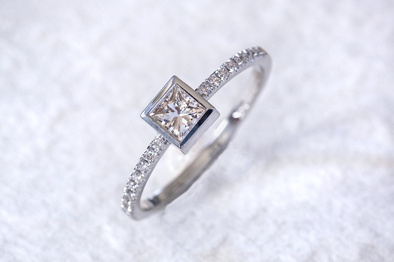 Engagement Ring With A Princess Cut Diamond And Diamonds On the Sides