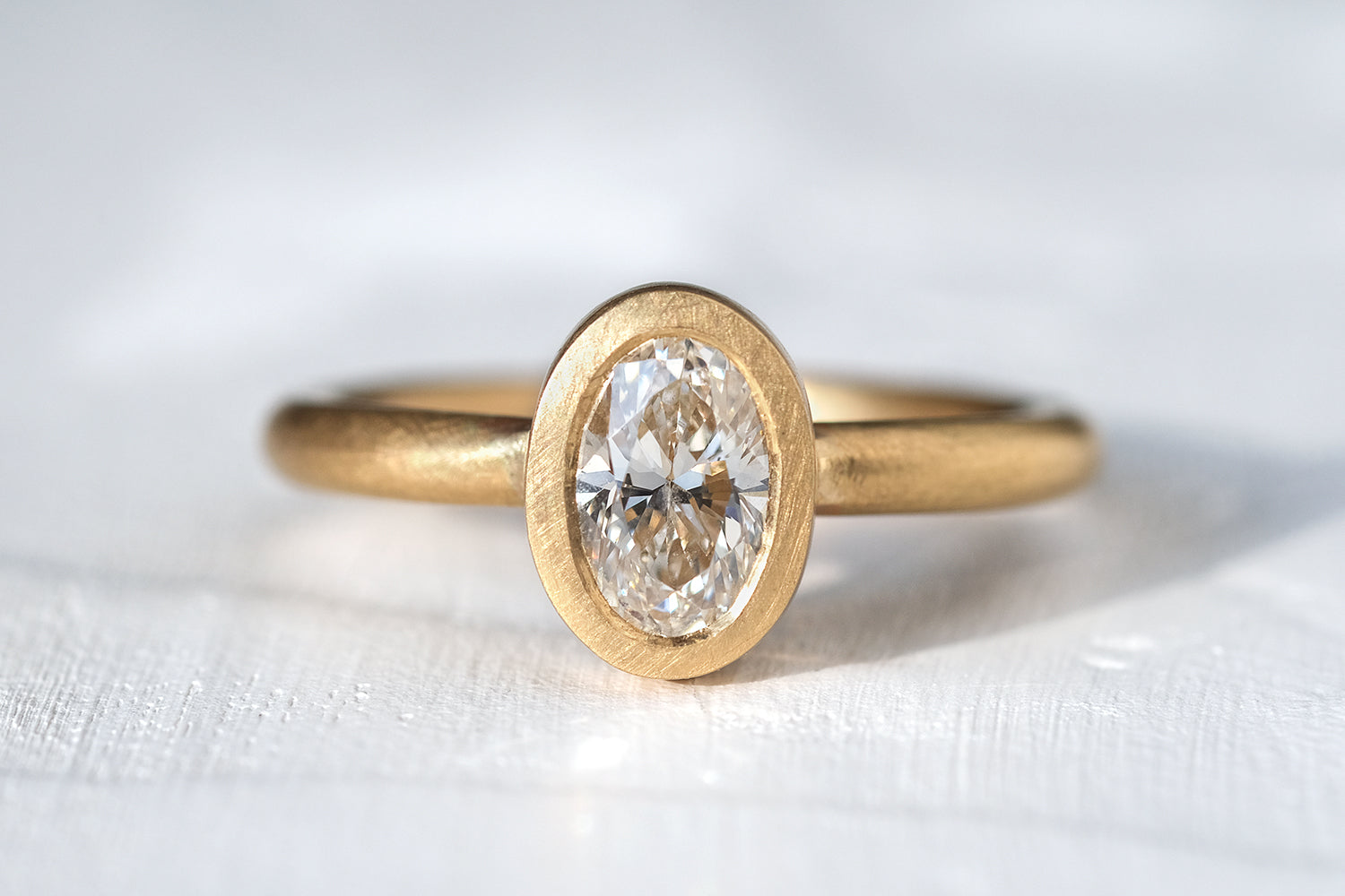 Gold Engagement Ring Set With An Oval Cut Diamond