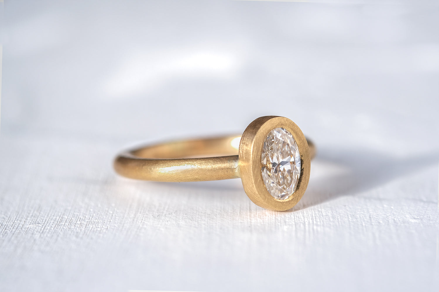 Gold Engagement Ring Set With An Oval Cut Diamond